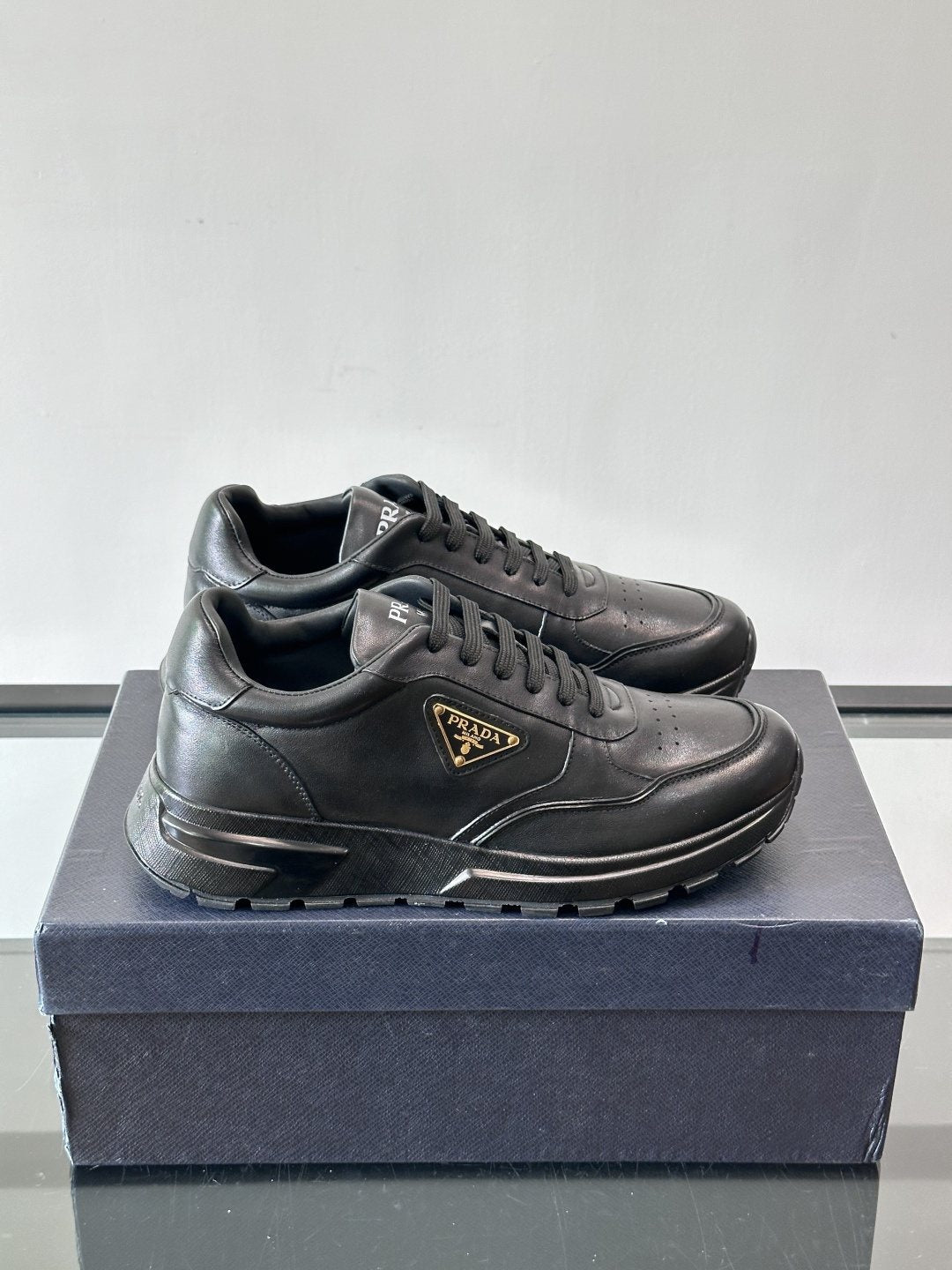 Prada Triangle Plaque Low-Top Sneakers — front