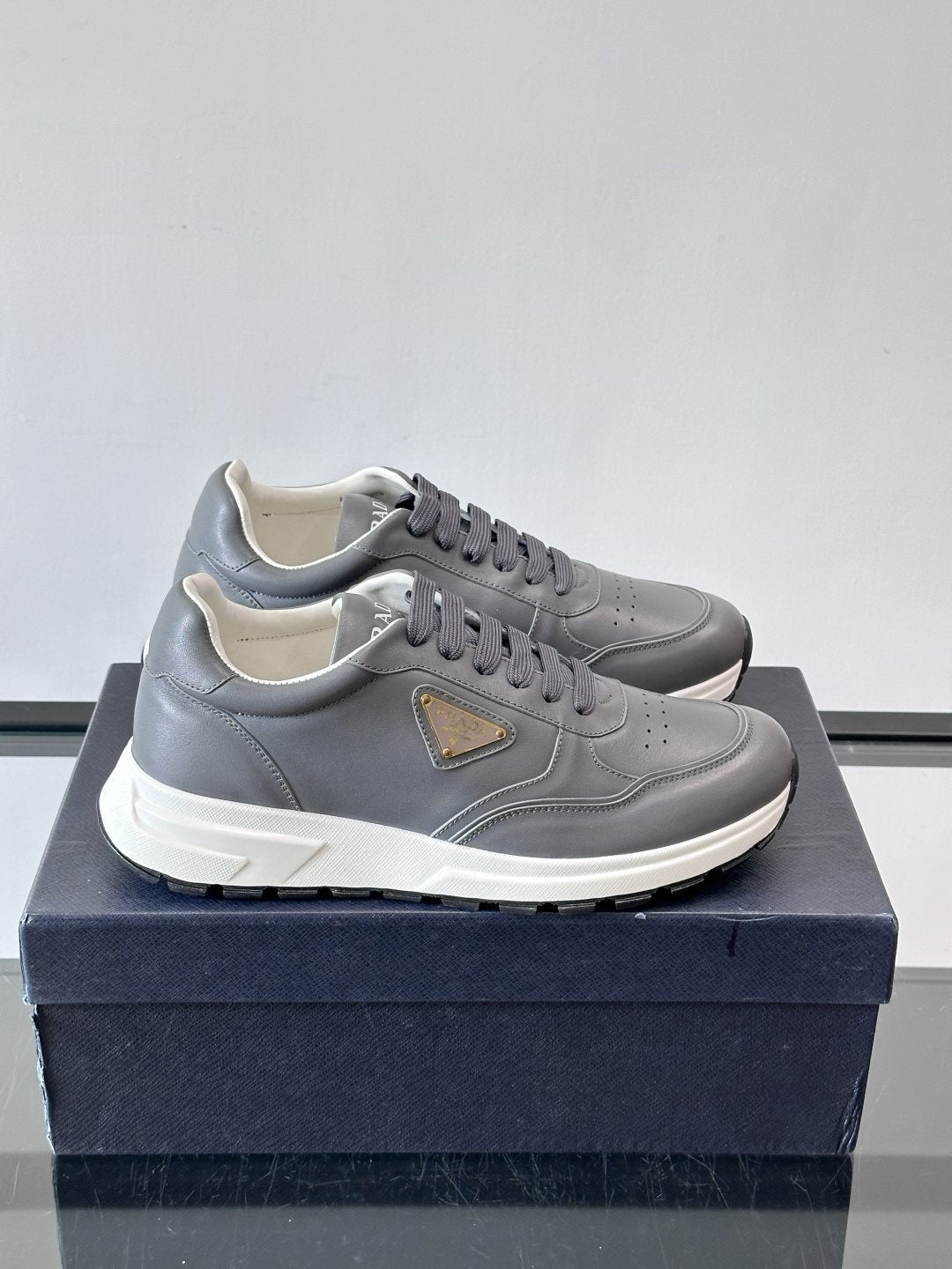 Prada Triangle Plaque Low-Top Sneakers — front